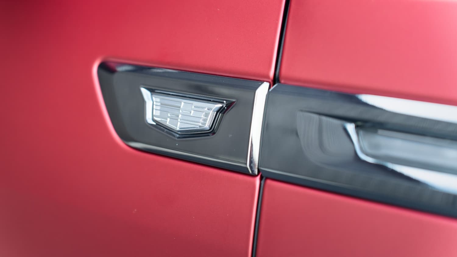 Satin red wrap detail on a Cadillac Escalade IQ