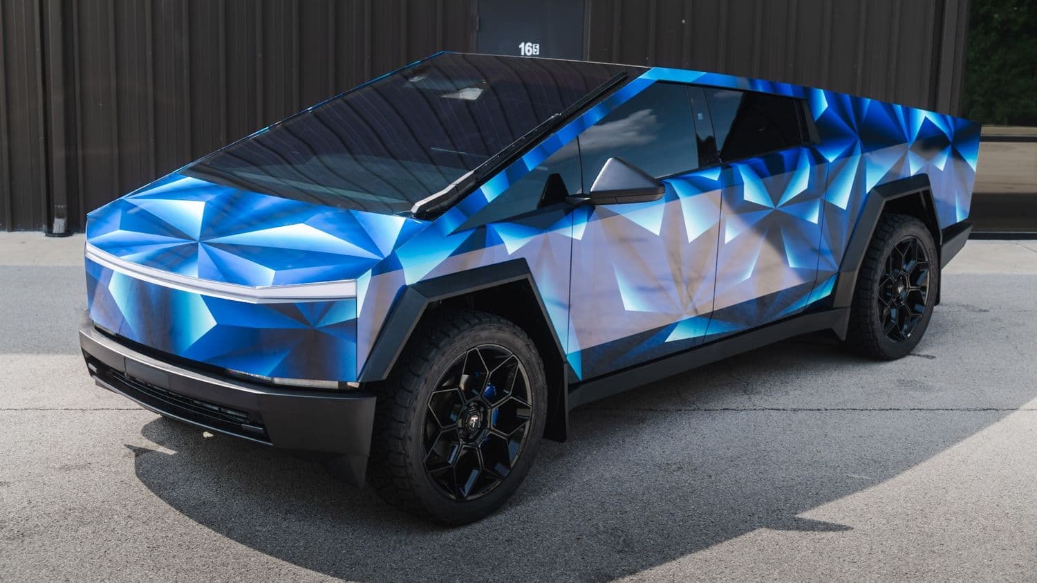 Cybertruck elevated front three-quarter in the geometric wrap